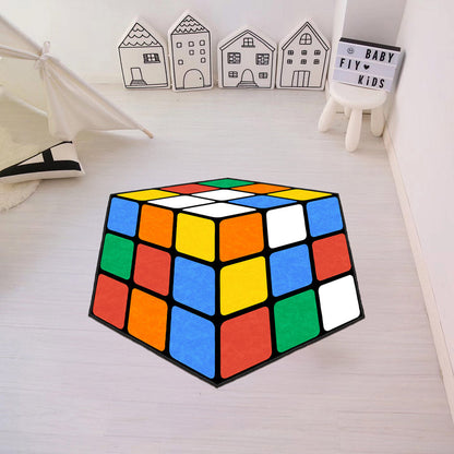 Colorful Rubik's Cube-shaped rug on a light wooden floor with decorative houses in the background.