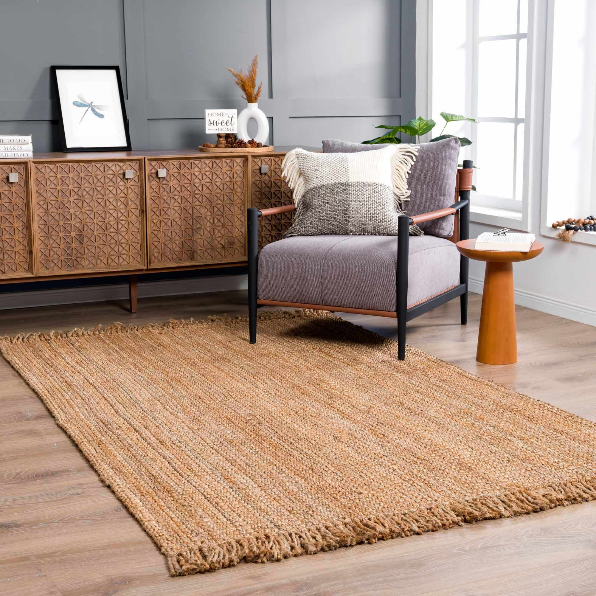 Living room with a textured rug, armchair, and wooden sideboard.