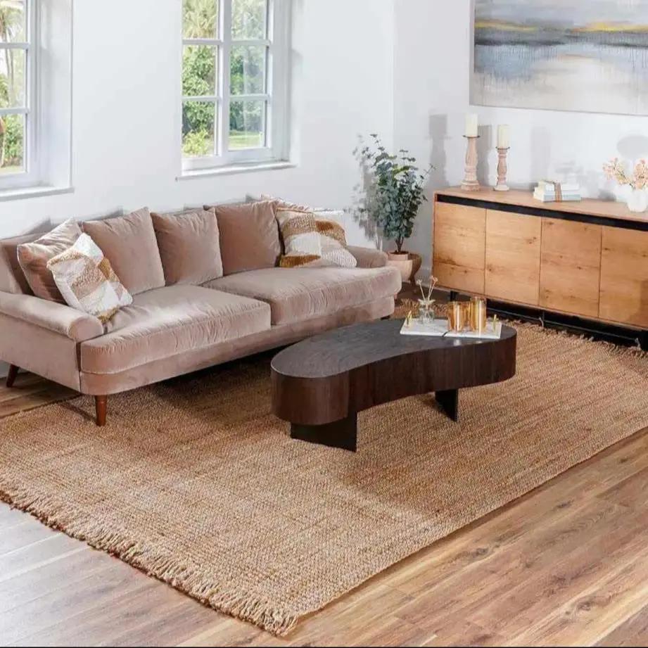Living room with a beige sofa, wooden coffee table, and a large rug.