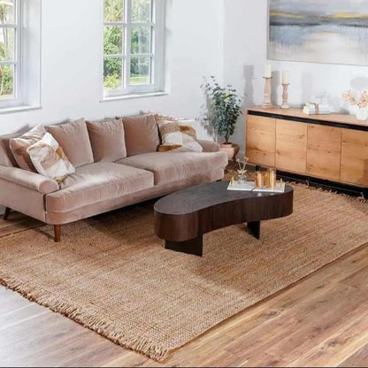 Living room with a beige sofa, wooden coffee table, and a large rug.