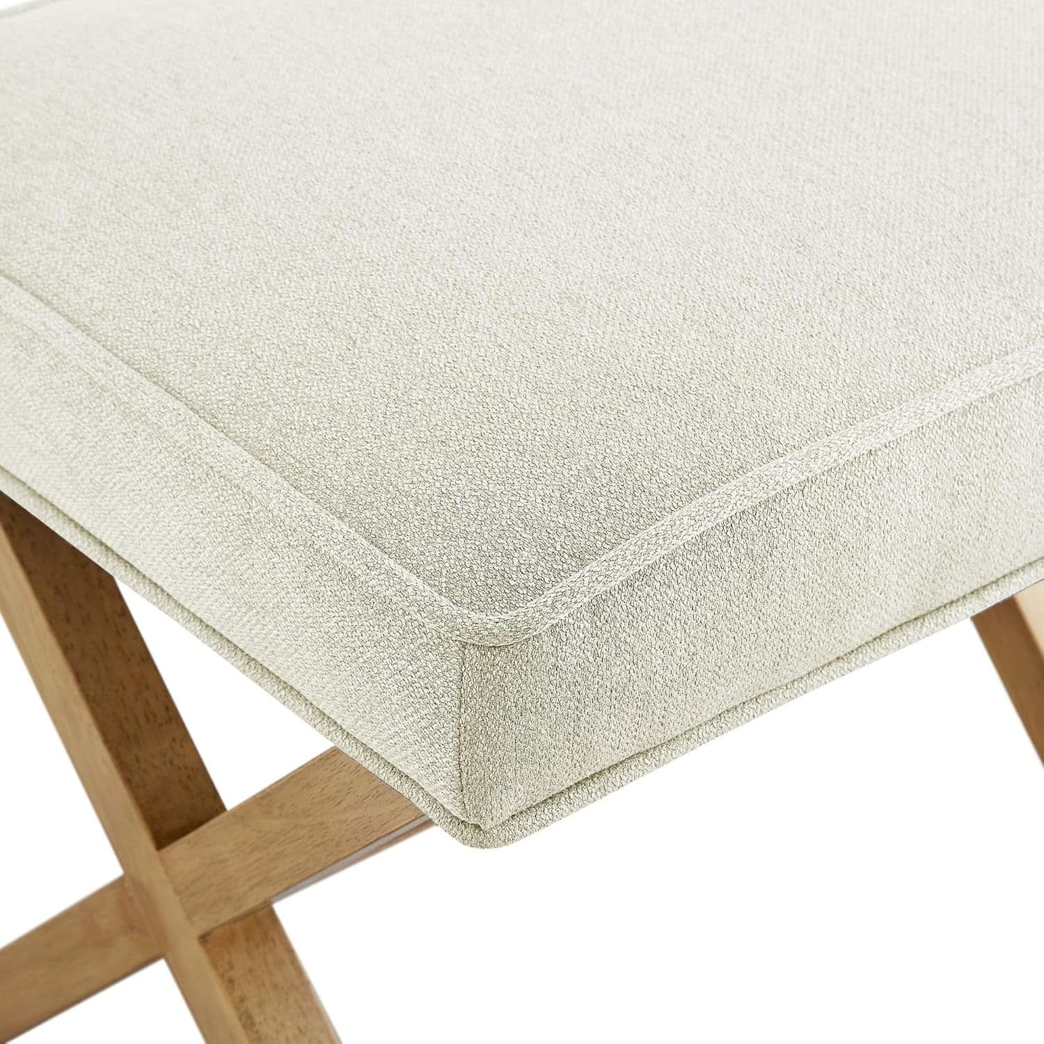 Close-up of a beige cushioned stool with wooden legs on a white background