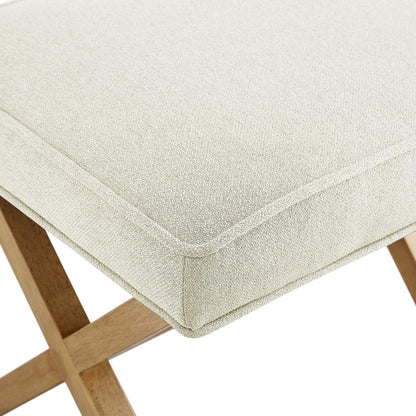 Close-up of a beige cushioned stool with wooden legs on a white background