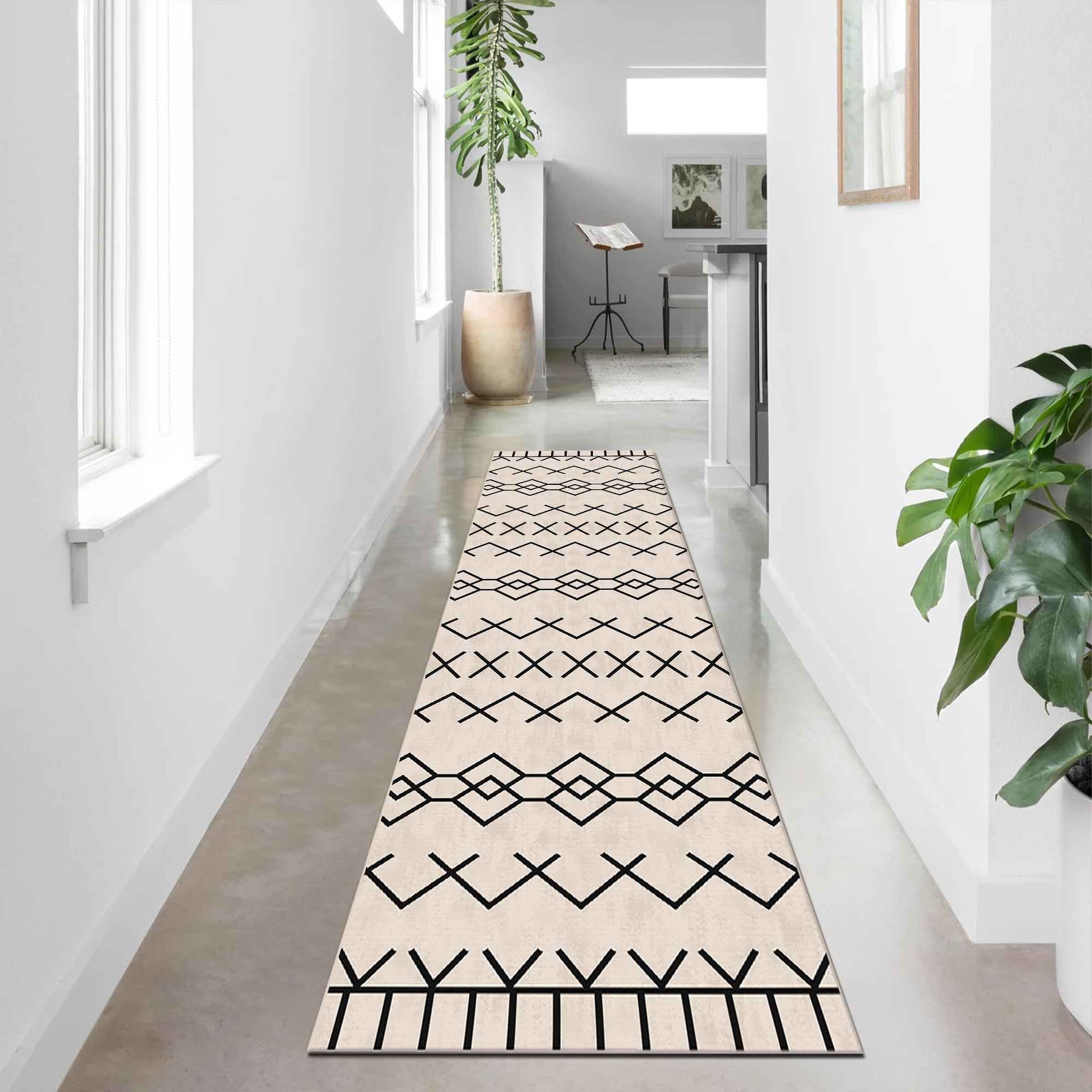 Long, narrow runner rug with geometric pattern on a light wooden floor.