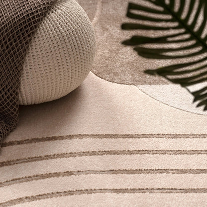 Close-up of a textured surface with a patterned pillow and leaf-like design.