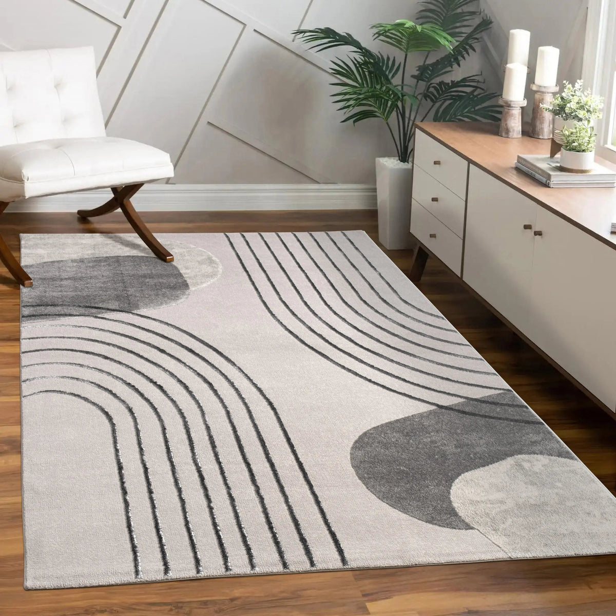 Modern living room with a gray and white patterned rug on wooden flooring.