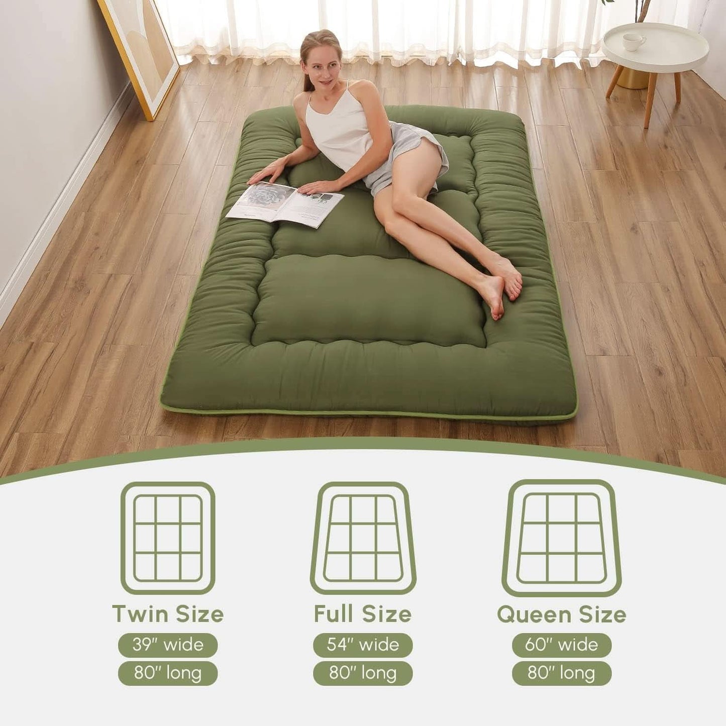 Woman lying on a green mattress in a room with wooden flooring.