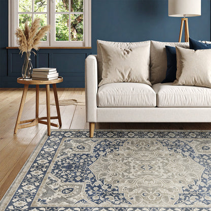 Living room with a patterned rug, beige sofa, and wooden side table.