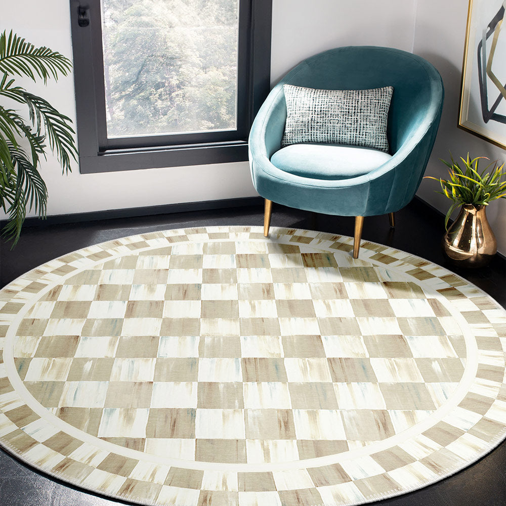 Round checkered rug in a room with a teal chair and window.