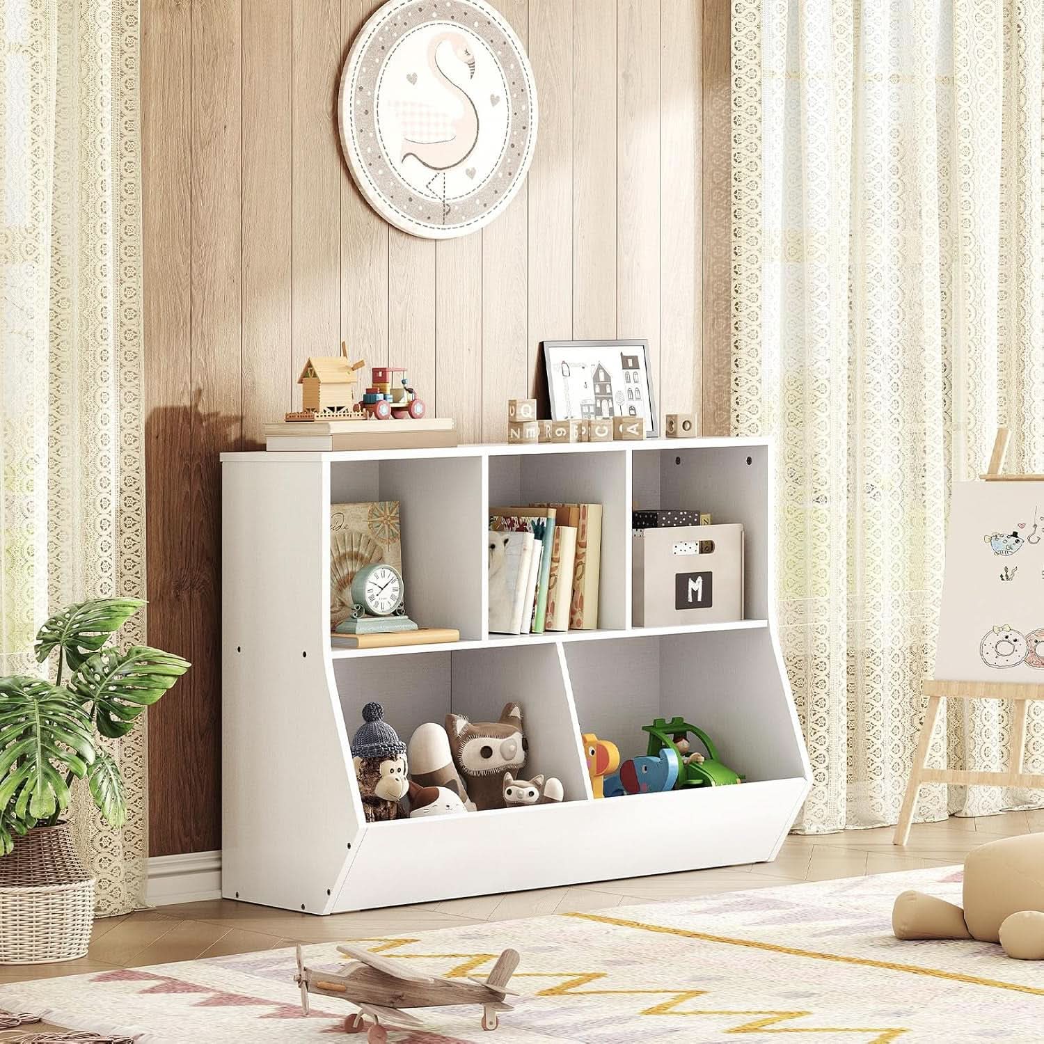 White bookshelf with toys and books in a room with wooden walls and curtains.